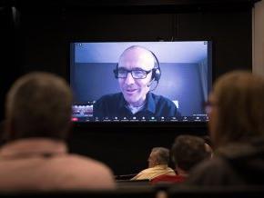 Chad Rimmer appears via Zoom on the large screen at Q&A session in Belk Centrum